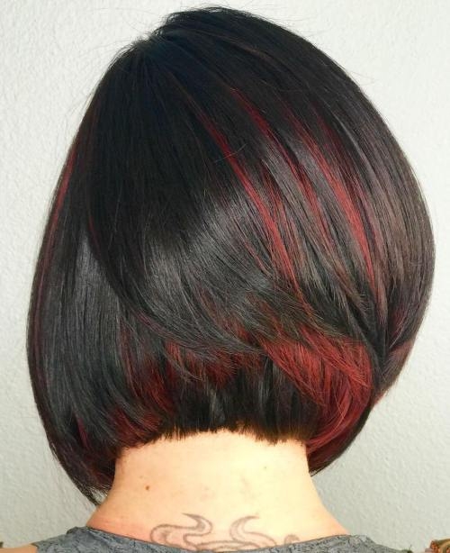 Dark brown bob with red peekaboo highlights, hidden under top layers, sleek straight texture