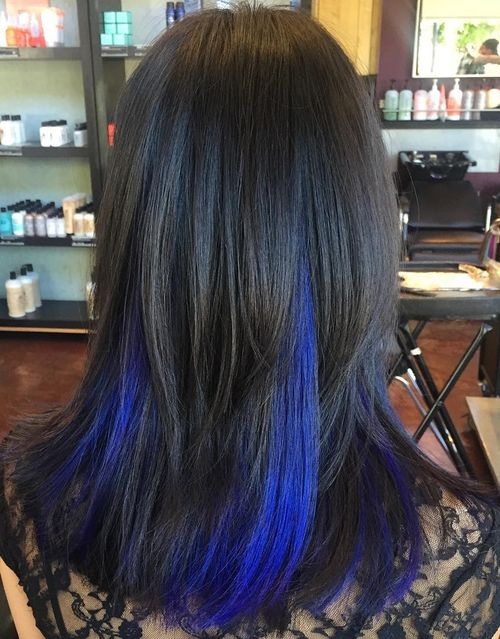 Long dark brown hair with vibrant blue peekaboo highlights under layers, smooth texture, salon setting