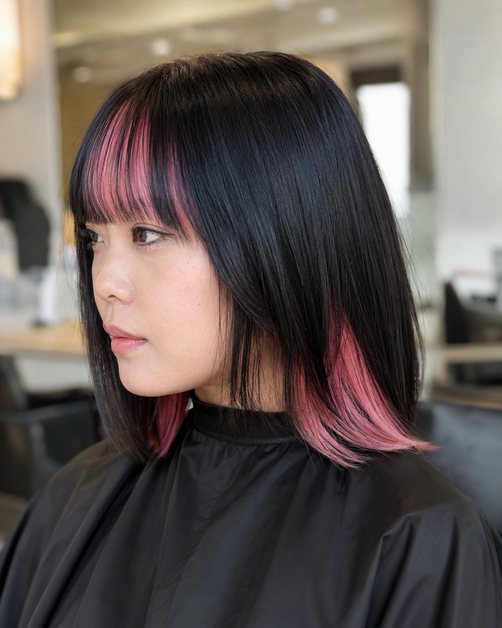 Black bob with pink underneath and slim pink sections beneath straight bangs