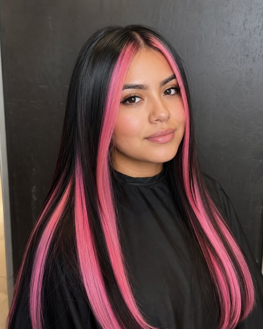 Long straight black hair with wide chunky bubblegum-pink highlights
