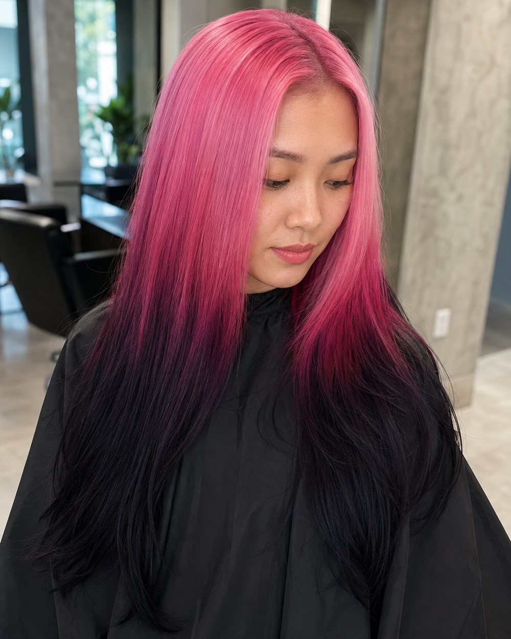 Long straight hair fading from pink roots through magenta to black ends