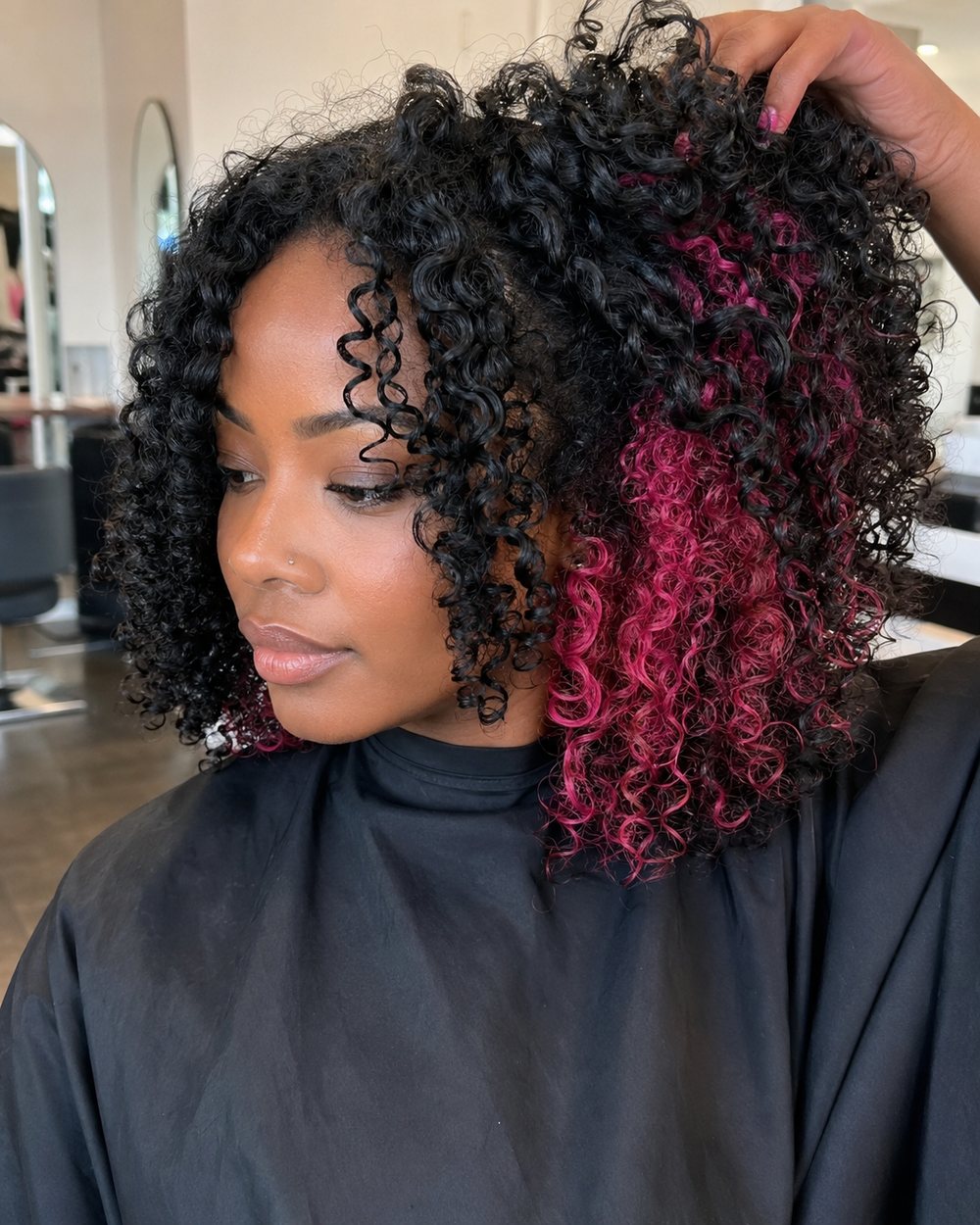 Natural black curls lifted to reveal raspberry-pink peekaboo curls