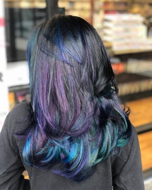 Blue black hair with subtle purple reflections and softly curled ends