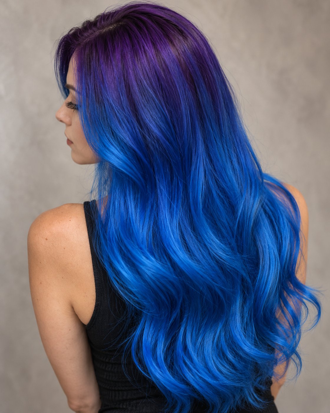 Long electric blue hair with deep purple roots and softly waved ends