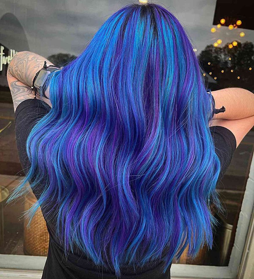 Long wavy hair with a blended indigo and violet color melt