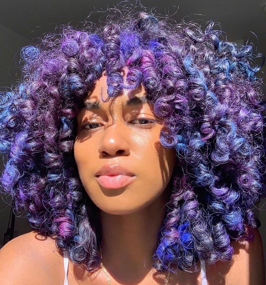 Natural curls with blue and purple hair color and violet accents