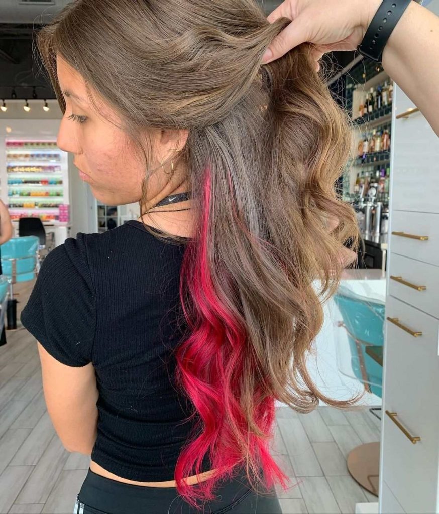 Peekaboo pink highlights brown hair