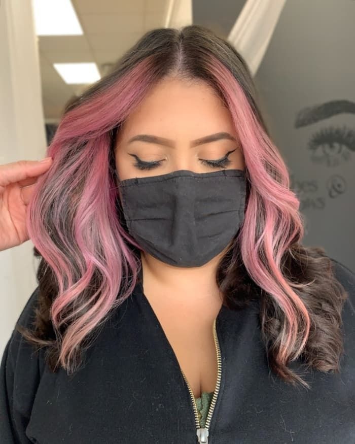 Pink face framing strands brunette hair
