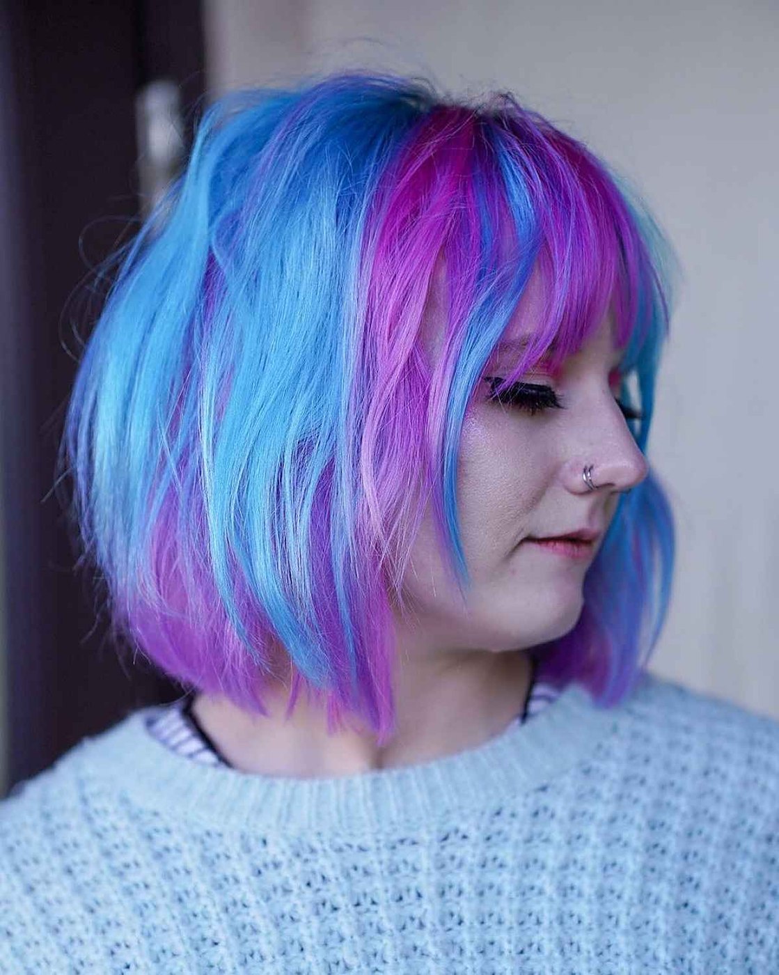 Pink purple and blue hair in a blunt shoulder length bob with bangs
