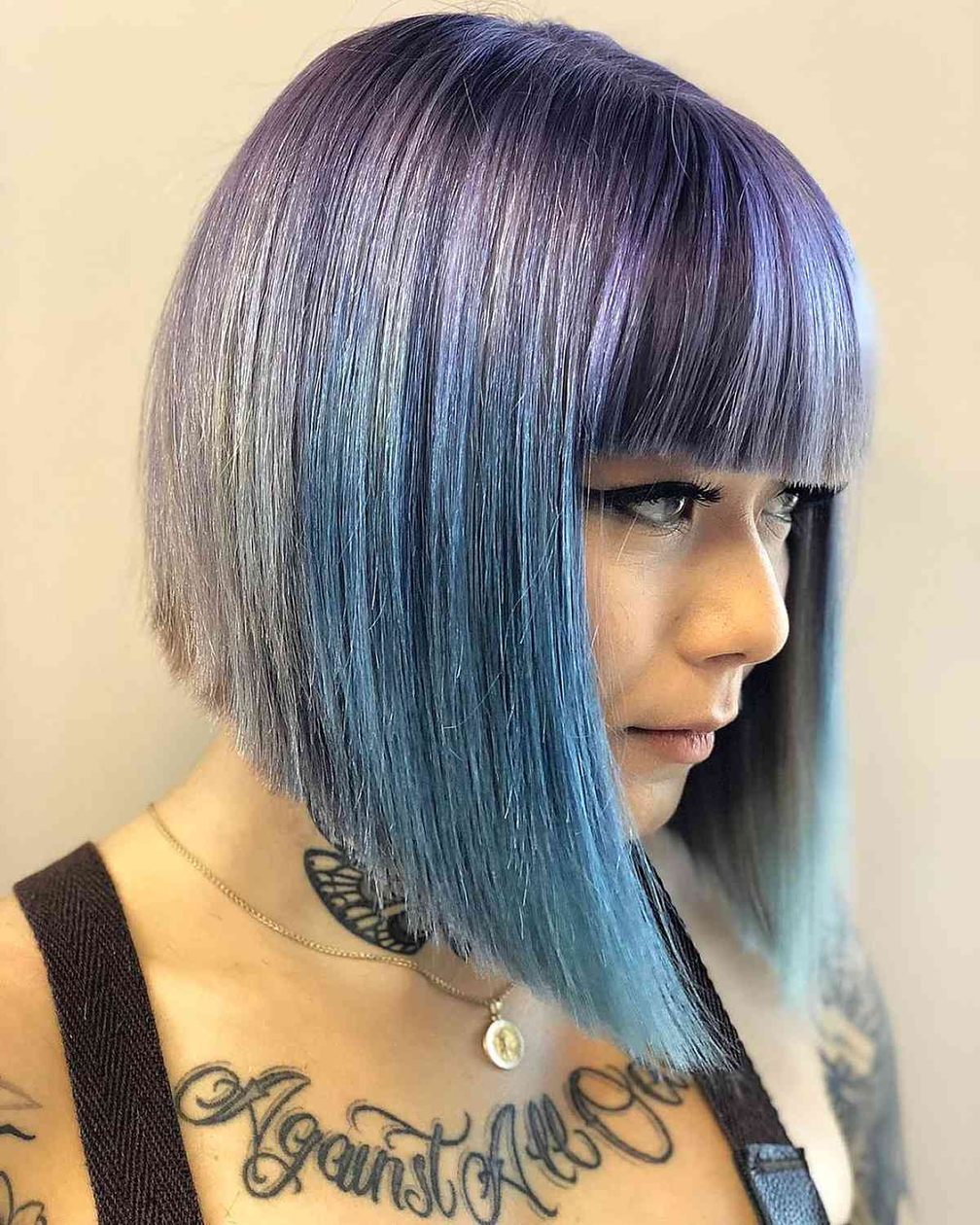 Smoky blue and dusty lilac hair on a sleek angled bob with bangs
