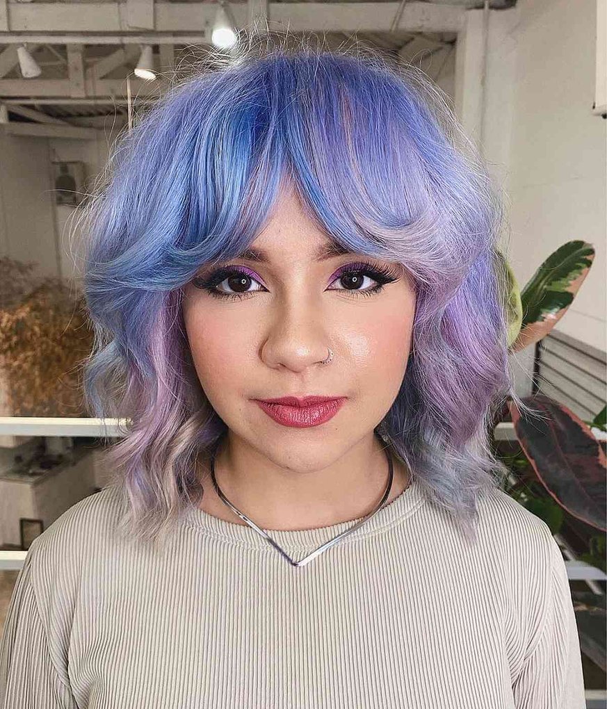 Wavy bob with soft blue and purple color and curtain bangs